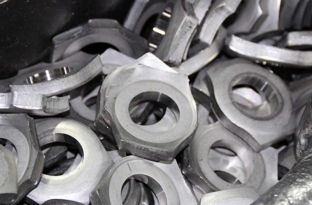 Blank 306L stainless steel watch cases after stamping but before pressing and machining